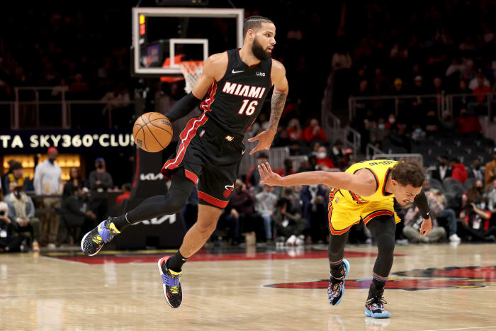 an 12, 2022; Atlanta, Georgia, USA; Miami Heat forward Caleb Martin (16) dribbles the ball against Atlanta Hawks guard Trae Young (11) during the first quarter at State Farm Arena.